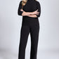Front view of a size 12 woman wearing a fuller bust mock neck pullover paired with matching black high waisted wide leg trousers featuring in-seam pockets.