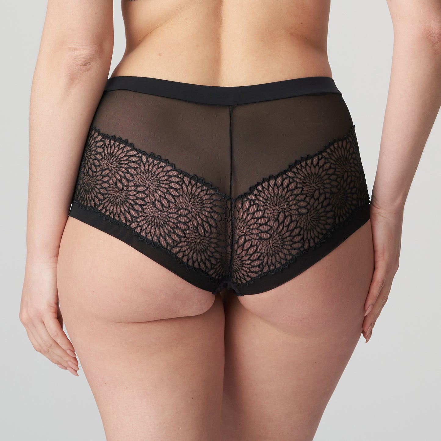 Back view of a woman wearing the Sophora high-waisted cheeky panty in Black by PrimaDonna.