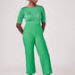 Front view of a woman wearing a half sleeve crew neck fuller bust T-shirt paired with matching wide leg cropped pants in vibrant kiwi green by Miriam Baker.