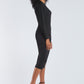 Side view of woman wearing a dolman sleeve batwing pullover in black bamboo paired with a stretch crepe ruched pencil skirt by Miriam Baker.