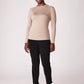 Front view of a woman wearing a beige bamboo crew neck raglan sleeve fuller bust pullover designed by Miriam Baker.