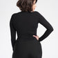 Detailed back view of a woman wearing a black bamboo crew neck raglan sleeve fuller bust pullover designed by Miriam Baker.