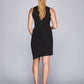 Back view of a woman wearing a fuller bust bodycon little black dress with a crew neck and asymmetric hem by Miriam Baker.