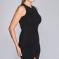 Close up side view of a woman wearing a fuller bust bodycon little black dress with a crew neck and asymmetric hem by Miriam Baker.