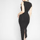 Back view of a woman wearing a black stretch viscose fuller bust midi length bodycon dress with shoulder ruffles and a back slit designed by Miriam Baker.