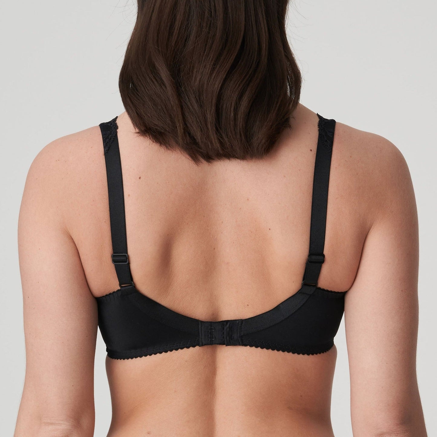 Back view of a woman wearing the DD+ Madison full cup bra in black by PrimaDonna.
