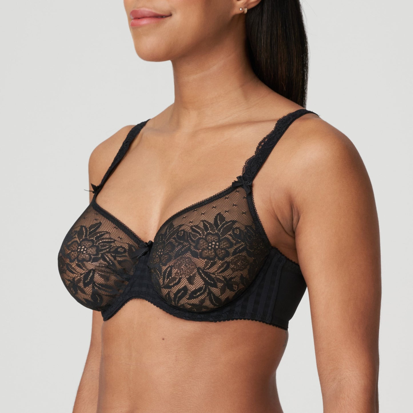 Side view of a woman wearing the DD+ Madison Unpadded Seamless T-Shirt Bra in Black by PrimaDonna.