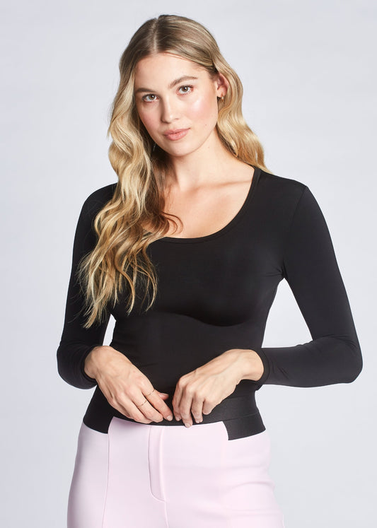 Front view of a woman wearing a black fuller bust long sleeve scoop neck pullover designed by Miriam Baker.