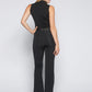 Back view of a woman wearing a black stretch viscose fuller bust mock neck tank top paired with stretch bell bottom trousers designed by Miriam Baker.