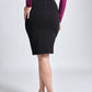 Back view of a woman wearing a violet coloured pullover paired with a black stretch viscose skirt by Miriam Baker.