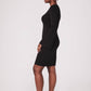 Side view of a woman wearing a black stretch viscose fuller bust princess line split sleeve bodycon dress with a crew neck and invisible zipper designed by Miriam Baker.