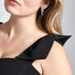 Front detailed view of a woman wearing a black stretch viscose fuller bust dropped waist dress with full skirt and shoulder bows designed by Miriam Baker.