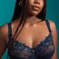 A woman wearing a supportive full cup lace underwire bra for large breasts in velvet blue by PrimaDanna.