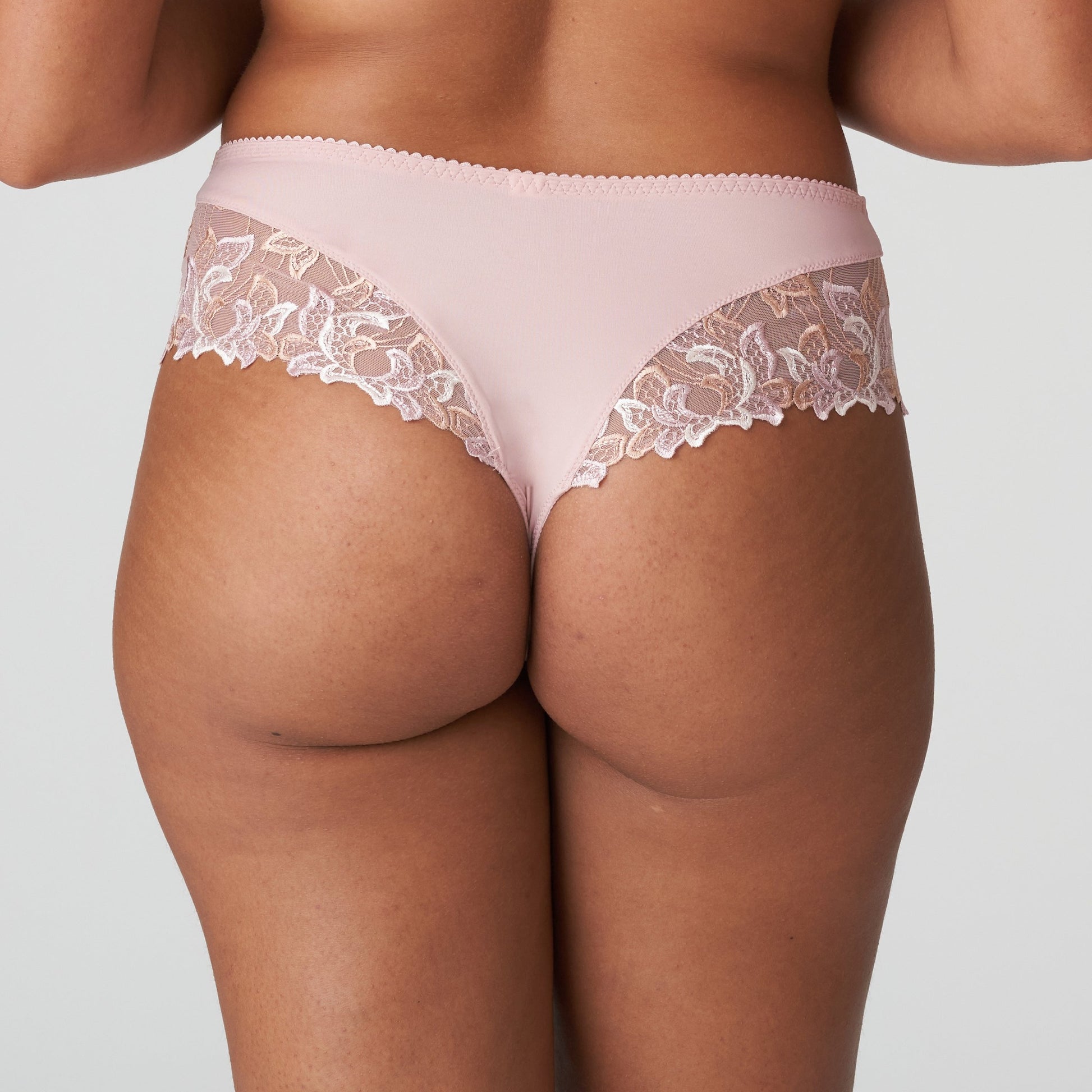 Back view of a woman wearing the Deauville Luxury Thong with elegant lace in Vintage Pink by Primadonna.