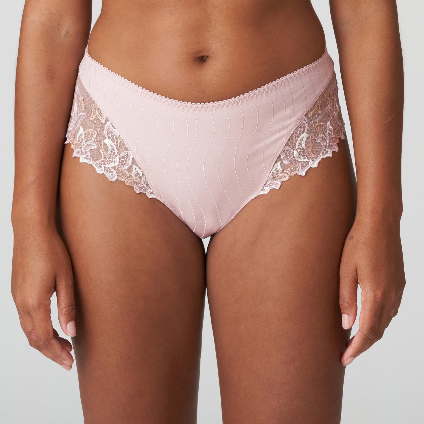 Woman wearing the Deauville Luxury Thong with elegant lace in Vintage Pink by Primadonna.