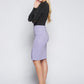 Side view of a woman wearing a knee length stretch viscose pencil skirt with side slit and back invisible zipper in lilac by Miriam Baker.
