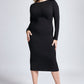 Woman wearing a black stretch raglan sleeve fuller bust midi length bodycon dress with boatneck, long sleeves, back slit and invisible zipper by Miriam Baker.