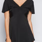 Woman wearing a fuller bust low cut v-neck top with a butterfly twist detail at the empire waist in black stretch viscose jersey by Miriam Baker.