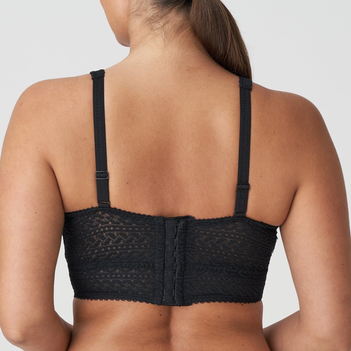Back view of a woman wearing the Montara DD+ wireless longline full support bralette in black lace by PrimaDonna.