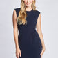 Woman wearing a Navy stretch viscose fuller bust sheath dress with pockets and cap sleeves designed by Miriam Baker.