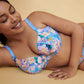 A woman laying down wearing the Madison Moulded Cup Bra with light padding in Periwinkle Floral by Primadonna.
