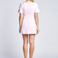 Back view of a woman wearing a pale pink fuller bust mini dress with stretch featuring a boatneck and short sleeves designed by Miriam Baker and made in Canada.