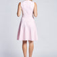 Back view of a woman wearing a baby pink fit and flare fuller bust sleeveless crew neck dress with invisible zipper by Miriam Baker.