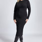 Woman wearing a black raglan sleeve fuller bust midi length stretch bodycon dress with back slit and invisible zipper by Miriam Baker. 
