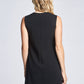 Back view of a woman wearing a black semi-fitted-fuller bust A-line shift dress with a crew neck and welt pockets designed by Miriam Baker.