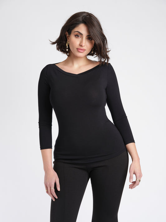 Woman wearing a black 3/4 length sleeve fuller bust bamboo pullover with stylized boatneck by Miriam Baker.