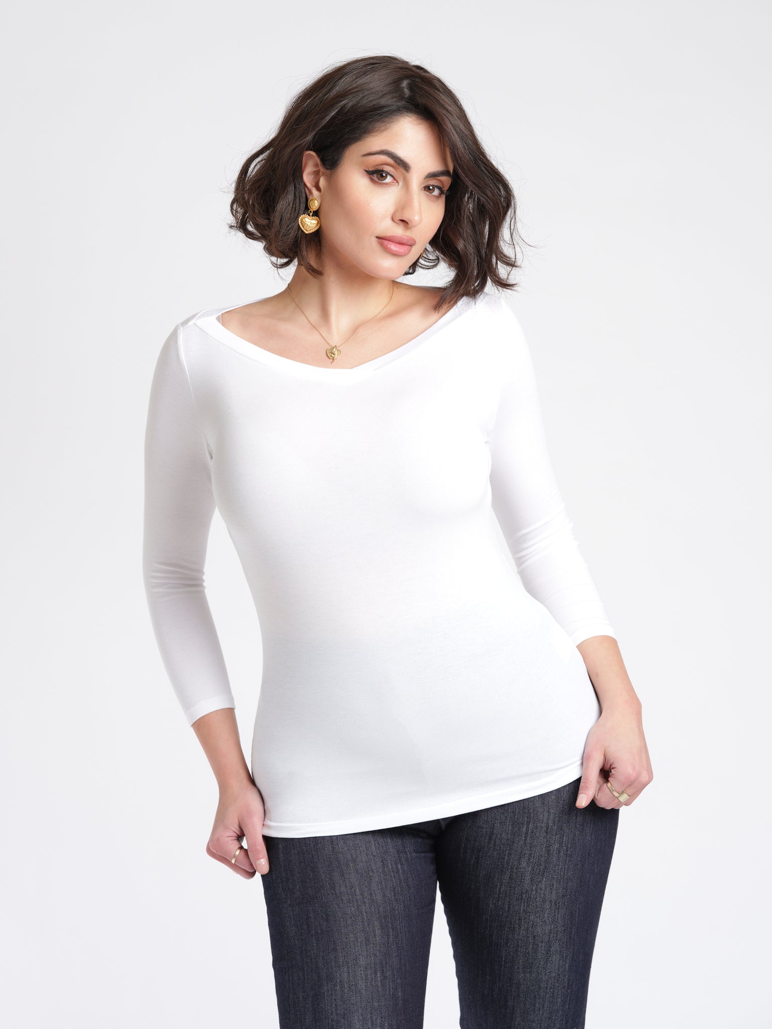 Woman wearing a white 3/4 length sleeve fuller bust bamboo pullover with stylized boatneck by Miriam Baker.
