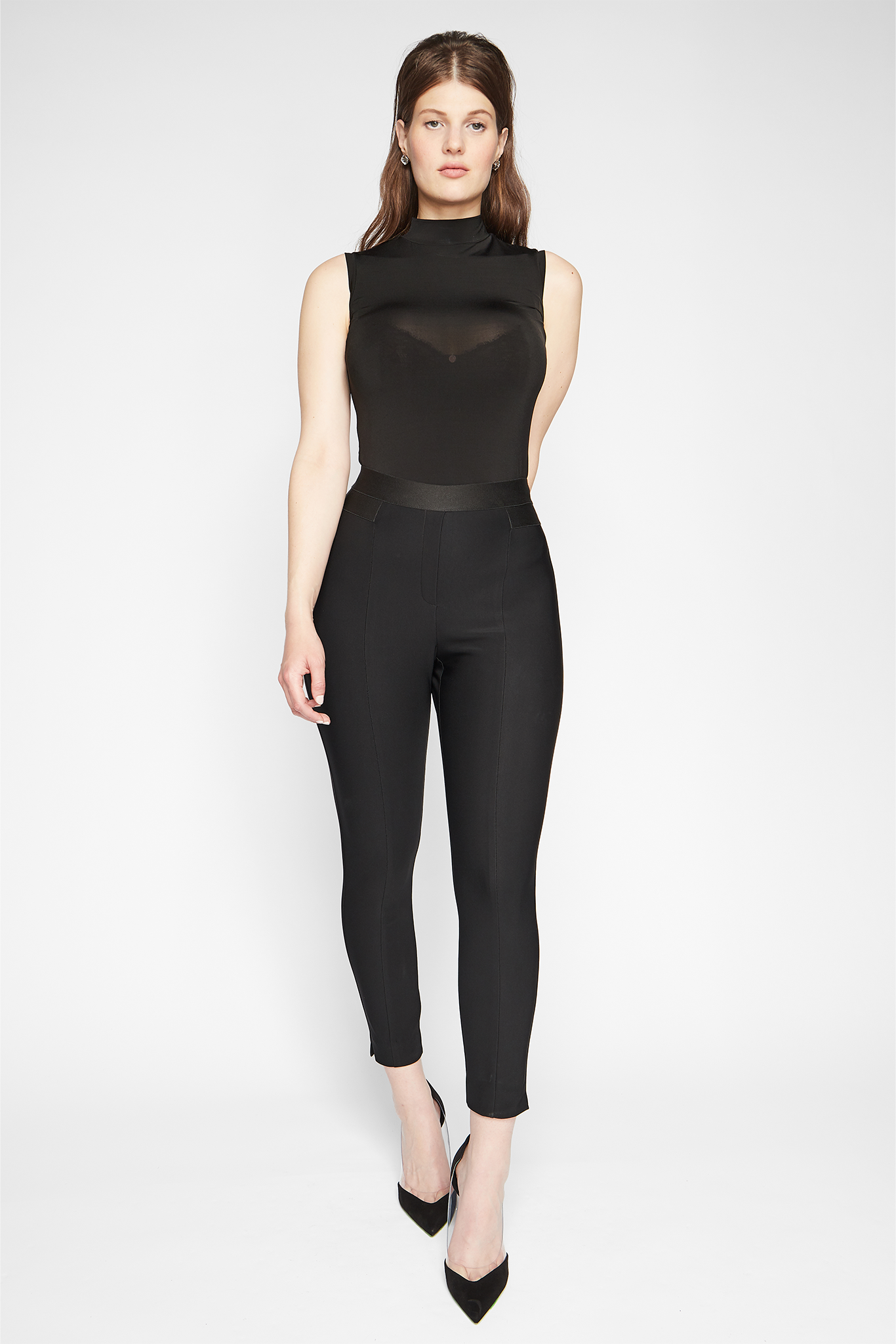 Front view of a woman wearing a black stretch viscose cropped pant with elastic waistband designed by Miriam Baker.