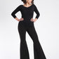 Woman wearing a black 3/4 length sleeve fuller bust bamboo pullover with stylized boatneck paired with bell bottom pants by Miriam Baker.