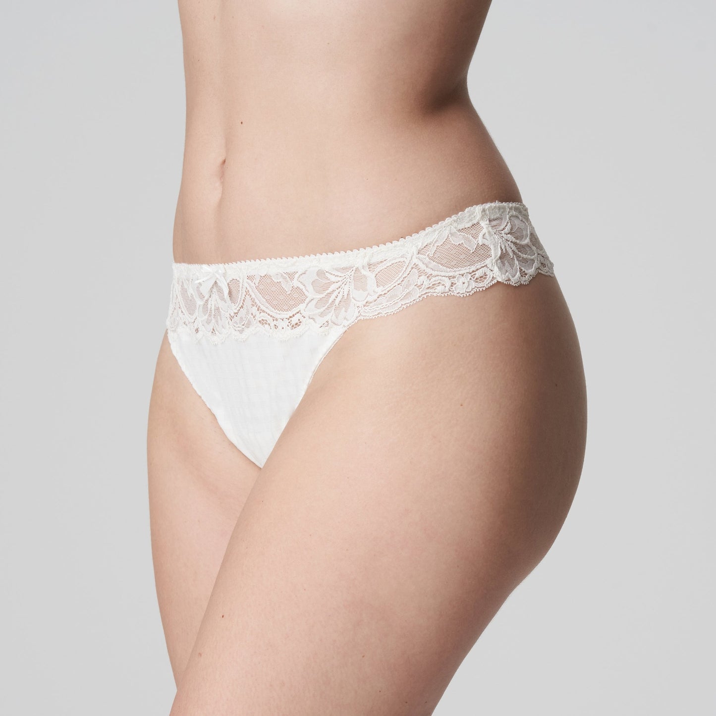 Side view of a woman wearing the Madison Thong in Natural by PrimaDonna.