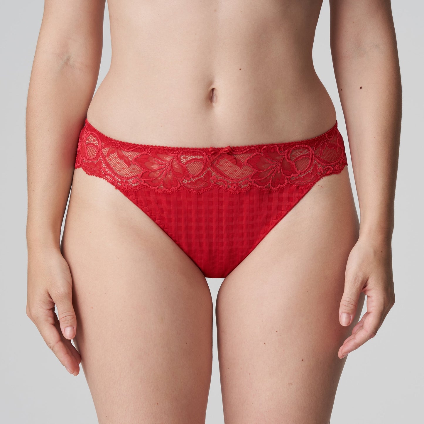 Front view of a woman wearing the Madison Thong in Scarlet by PrimaDonna.