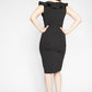 Back view of a woman wearing a stretch viscose fuller bust v-neck sheath dress with ruffles that frame the neckline in black designed by Miriam Baker.