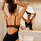 Back view of a woman wearing a black DD+ open back bodysuit with built in full support underwire bra by Primadonna.