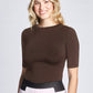 Woman wearing a fitted viscose crew neck fuller bust half sleeve T-shirt, tucked in front view of the Aarti Shirt in Henna brown by Miriam Baker.