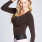 Side view of a woman wearing a fuller bust long sleeve scoop neck pullover in Henna designed by Miriam Baker.