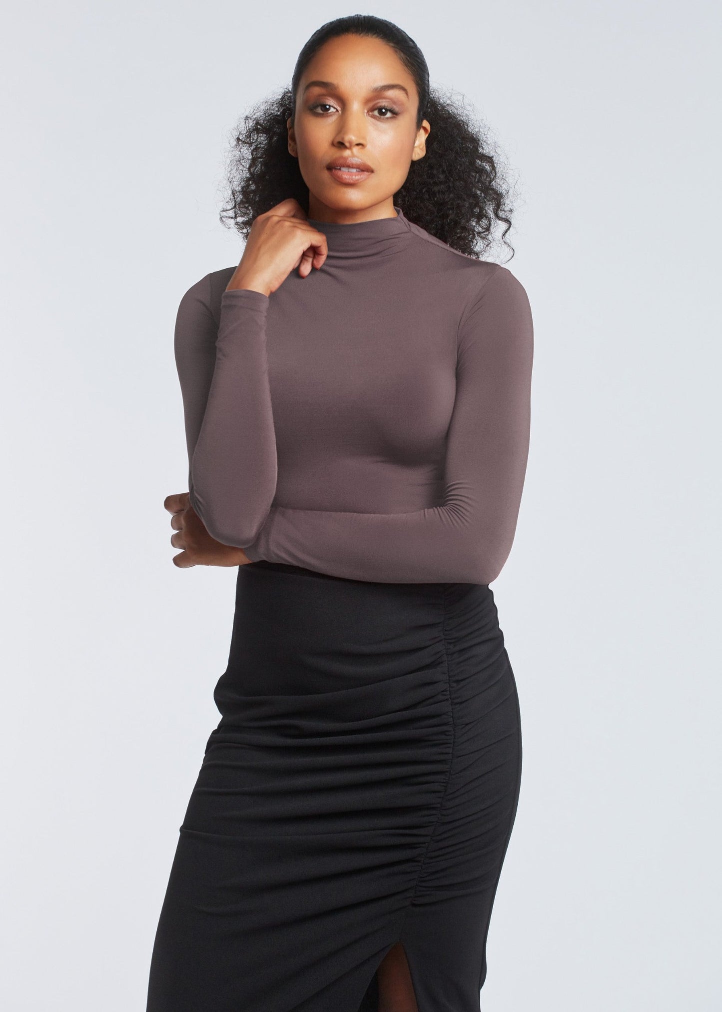 Woman wearing a stretch viscose fuller bust long sleeve mock neck pullover in quartz by Miriam Baker.